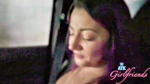 POV closeup of brunette girlfriend with eyes closed in pleasure during car blowjob