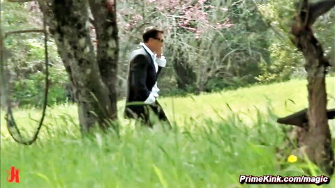 Suited man approaches bound busty woman in woods for rough outdoor fuck