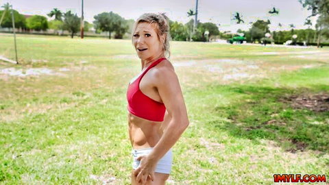 Madison Brite flexing her fit athletic body in red sports bra and white shorts