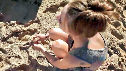 Hot teen in gray tank top squatting on sunny beach, amateur POV adventure