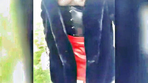 Sissy outdoor exhibition in black corset, red skirt and coat