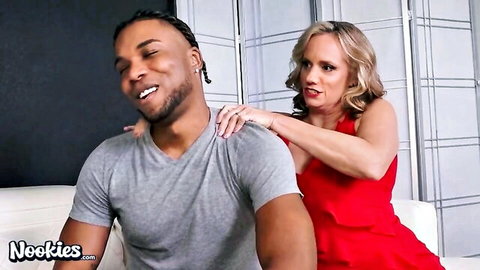 Blonde MILF in red dress seductively grabs black stud's shoulders teasing interracial sex