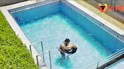 Indian MILF held intimately by man in blue pool water
