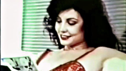 Seductive vintage brunette in sheer red lace bra teasing her big tits and cleavage