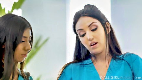 Lena Paul and Violet Myers in blue scrubs, close encounter
