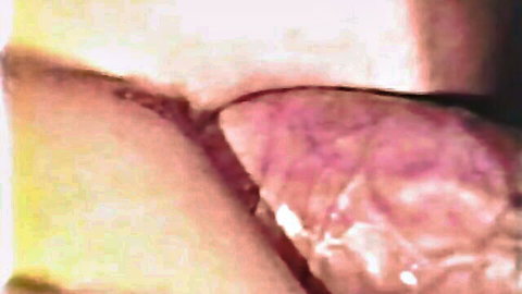 Extreme closeup of wet pink pussy interior revealing cervix and vaginal folds