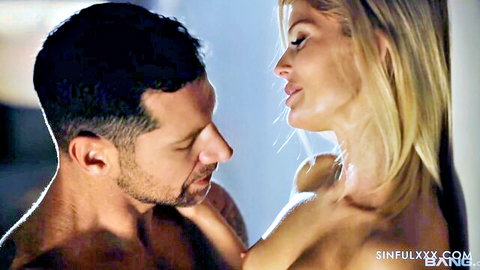 Nude blonde with perky tits passionately kissing muscular bearded hunk
