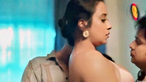 Brunette with big tits topless embraced from behind by man while kissing woman in threesome tease