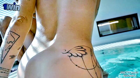 Nigonika nude from behind in jacuzzi, wet body with angel wing tattoo