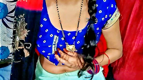 Indian bhabhi in blue saree blouse with midriff exposed, braided hair and jewelry