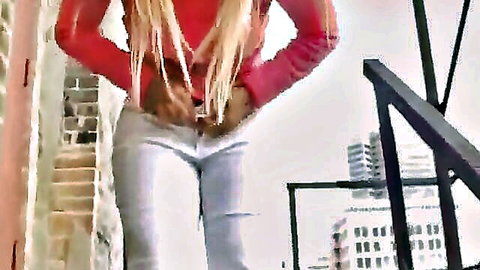 Big titted blonde flashing huge bare tits outdoors on urban balcony in red top
