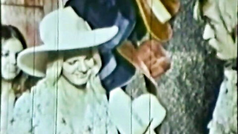 Vintage Mad Hatter themed classic porn with blonde woman in wide hat and dress, smiling with group