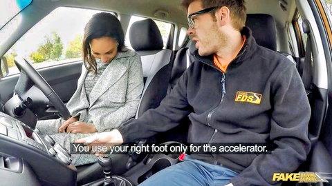 Sexy Asian driving instructor babe in gray suit teaches guy accelerator use in car POV
