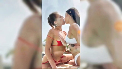 Two Italian lesbians in bikinis passionately kissing outdoors
