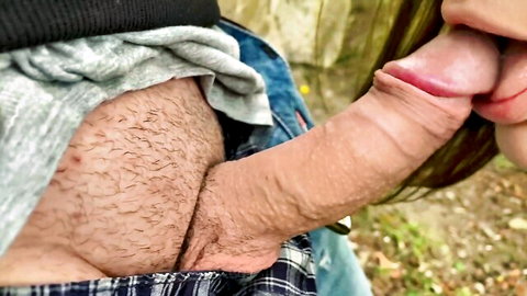 Green-haired woman sucking massive erect cock outdoors in woods