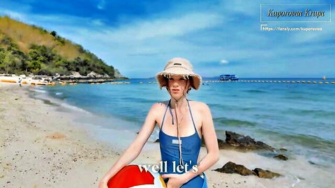 Sexy woman in tight blue swimsuit and hat posing on sunny beach holding red life preserver
