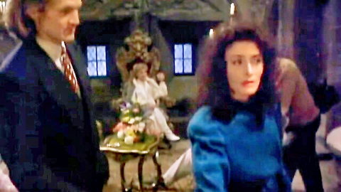 Elizabeth Shé in elegant blue dress, dramatic scene from Howling V