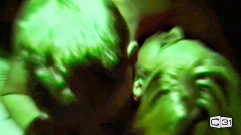 Vintage retro couple passionately kissing in blurry green-tinted closeup