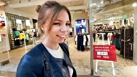 Smiling brunette in leather jacket shopping in store, teasing vibe