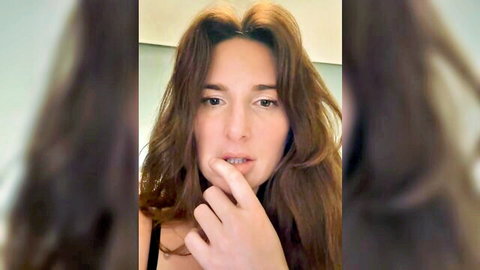 Thescorpionfr French brunette teasing with finger on lips, big tits in black top