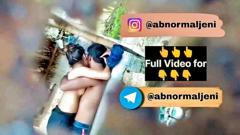Sexy Indian girl in intimate embrace with shirtless guy outdoors