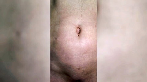 Close-up of pale mature MILF's belly button and smooth pubic mound teasing