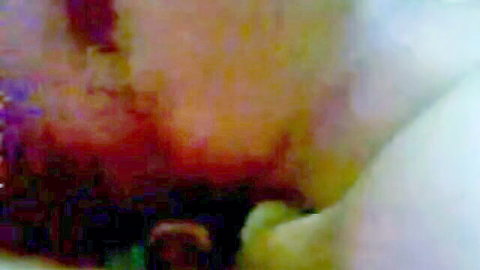 Blurry intimate close-up of Malay lovers' passionate embrace
