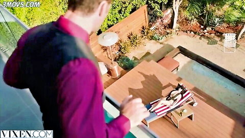 Suited man overlooks pool at busty nude babe with huge natural tits sunbathing on lounge chair