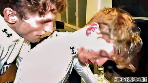 Two young ginger British chav lads kissing necks in racing gear