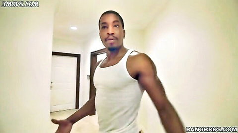 Muscular black stud flexes ripped arms in tight white tank top in hallway