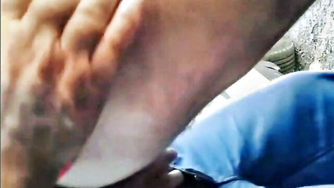 Blurry close-up of mature hand on bare female foot in parking lot sex scene