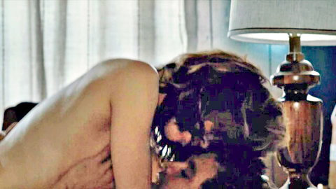Naked athletic blonde with small tits nuzzling nude man's neck in romantic bedroom embrace