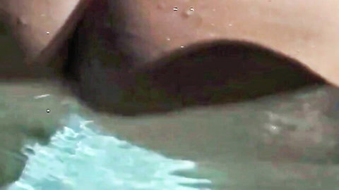 Busty brunette's massive wet tits with erect dark nipples spilling from turquoise bikini top