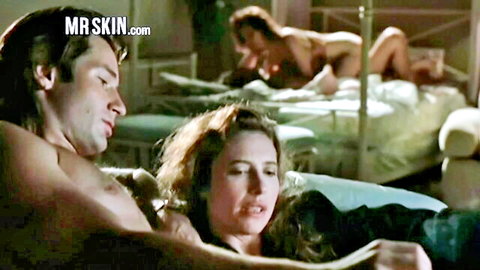 Celebrity orgy scene with nude brunette and redhead embracing shirtless man