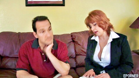 Mature redhead granny in revealing blouse with man on couch