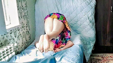 Girly in floral dress teases with butt-up pose in erotic solo adventure