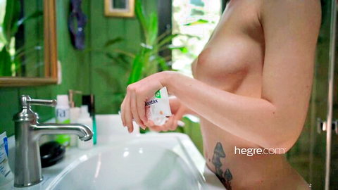 Nude Margo V. from Ukraine exposing breasts in bathroom scene