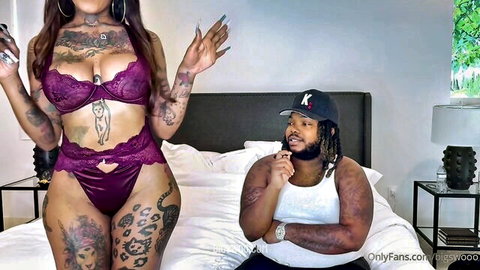 Tattooed curvy ebony babe in purple lace bra and thong teases chubby black dude on bed