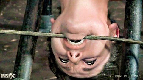 Sasha bound upside down with mouth gag in extreme BDSM scene, Infernal Restraints
