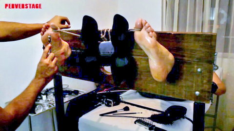 Woman's sexy feet tickled in stocks through black stockings