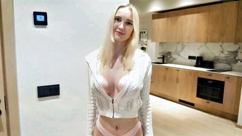 Slutty blonde in revealing white cardigan and pink panties showing deep cleavage