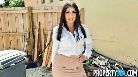 Brunette beauty in unbuttoned white shirt flashing big tits cleavage and tight beige skirt posing outdoors