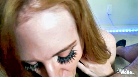 Redhead with heavy lashes looks up eagerly at man's crotch ready for blowjob