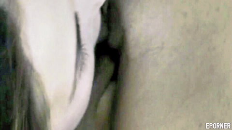Seductive close-up of woman's face with dramatic white eyelashes and sensual makeup gaze