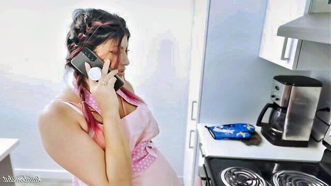Pregnant brunette MILF in pink apron talks on phone teasing bare curves and wet body