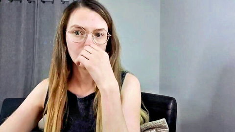 Ivorysunday on MyFreeCams, brunette with glasses in sleeveless top, casual pose