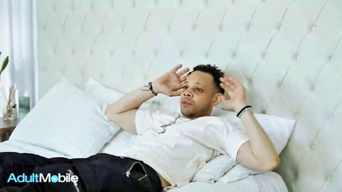 Donny Sins seductive pose on bed with Madi Collins in Petite Hotties scene