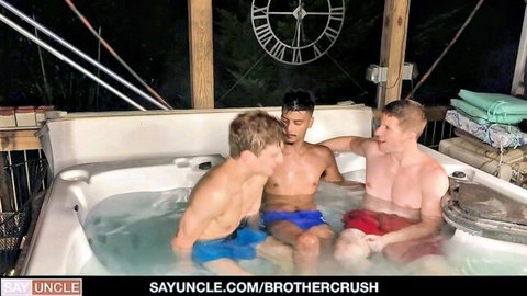 Three muscular guys in swim trunks share intimate hot tub moment, teasing gay threesome