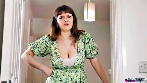Demi D in floral green dress with deep cleavage, standing pose
