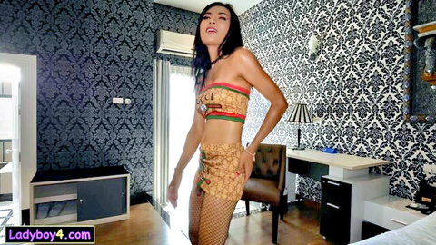 Petite Asian ladyboy Wan in sexy Guccy top, skirt and fishnets, hot dance pose